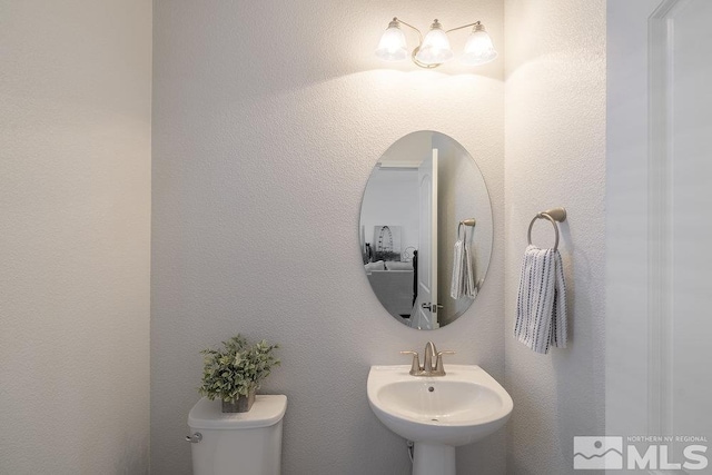 bathroom with toilet and sink