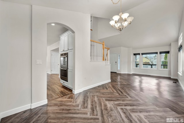 interior space featuring a notable chandelier and dark parquet floors