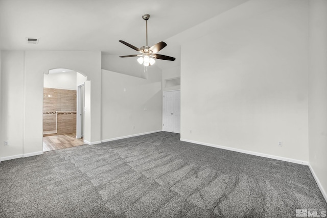 carpeted spare room with ceiling fan and lofted ceiling