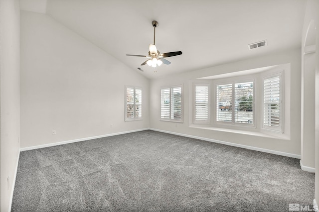 carpeted spare room featuring ceiling fan and lofted ceiling