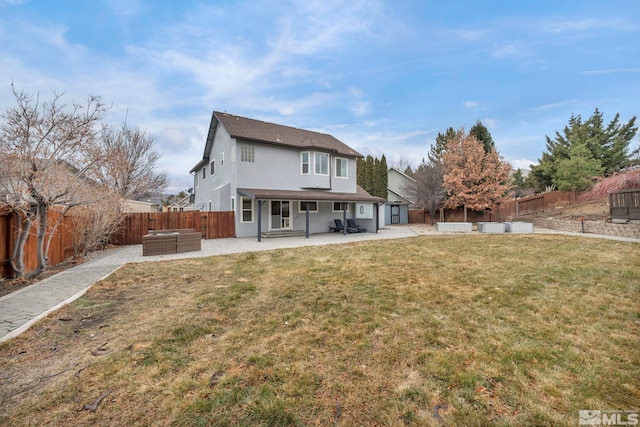 rear view of house with a patio area and a lawn