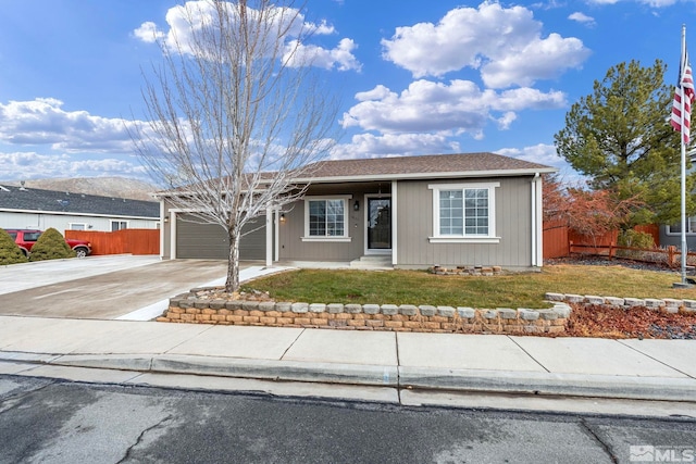 ranch-style house featuring a garage and a front lawn