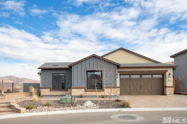 view of front facade featuring a mountain view and a garage