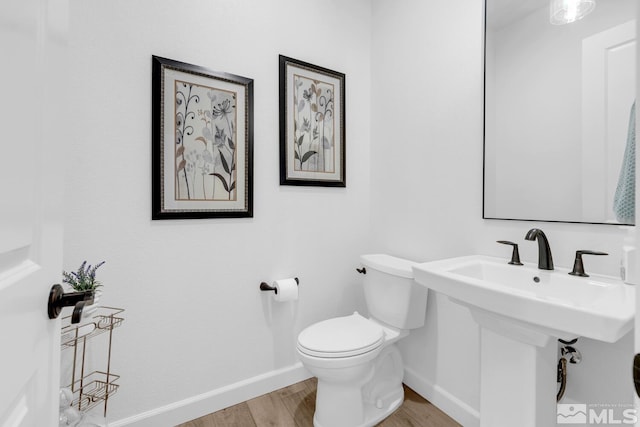 bathroom featuring hardwood / wood-style floors and toilet