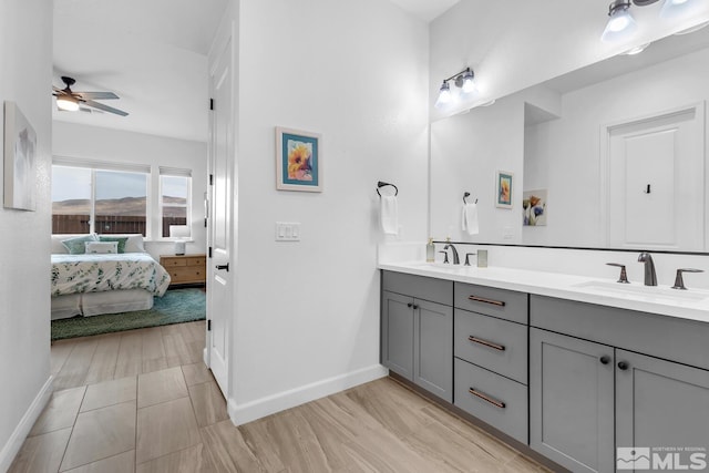 bathroom with ceiling fan, vanity, and hardwood / wood-style flooring