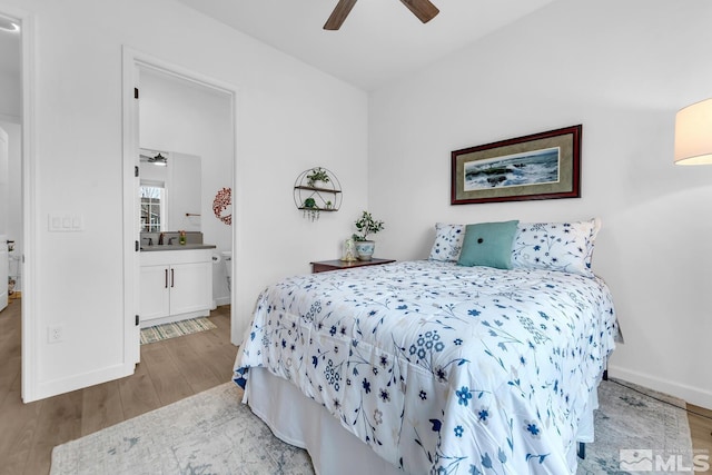 bedroom featuring connected bathroom, ceiling fan, and light hardwood / wood-style floors