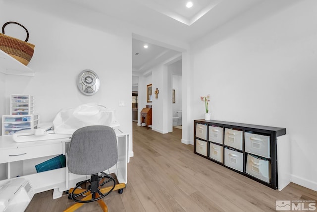 office with light wood-type flooring