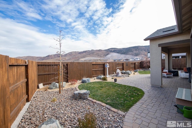 view of yard featuring a mountain view and a patio area