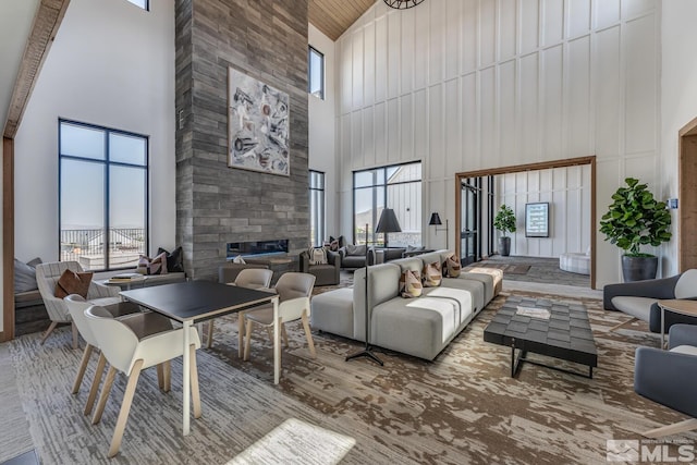 living room featuring a high ceiling and a large fireplace