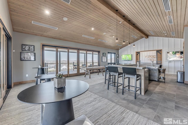 dining space with vaulted ceiling with beams and wooden ceiling