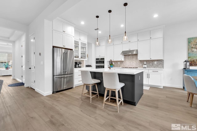 kitchen featuring a center island, white cabinetry, hanging light fixtures, and high end refrigerator