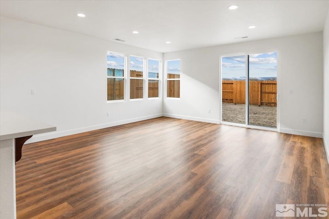 empty room with dark wood-type flooring