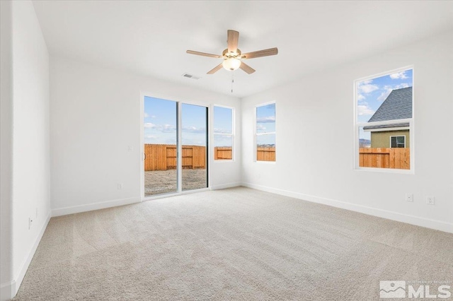 carpeted empty room featuring ceiling fan