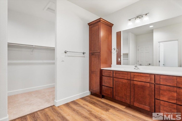 bathroom with vanity and hardwood / wood-style flooring