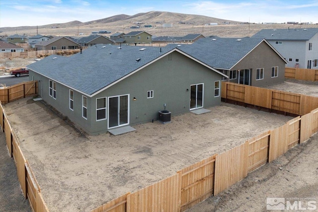 back of house with a mountain view and cooling unit