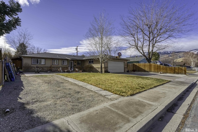 ranch-style home featuring a garage and a front lawn