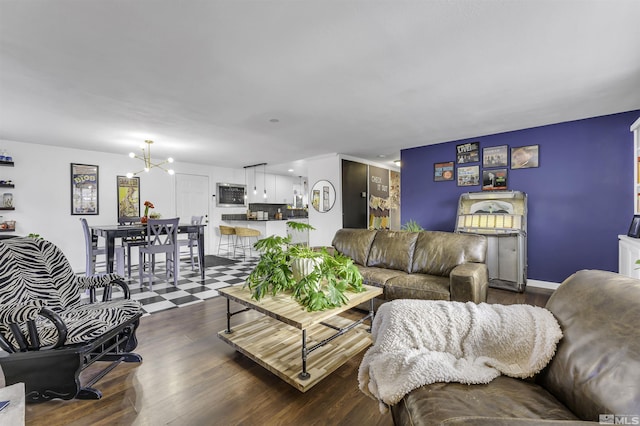 living room featuring dark hardwood / wood-style floors and an inviting chandelier