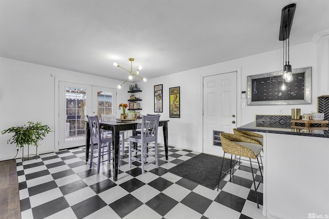 dining area featuring french doors and a notable chandelier