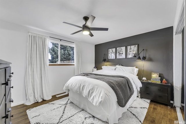 bedroom featuring ceiling fan and dark wood-type flooring