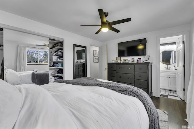 bedroom featuring ceiling fan, dark hardwood / wood-style flooring, and connected bathroom