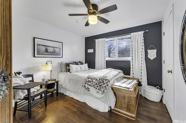 bedroom with dark hardwood / wood-style flooring and ceiling fan