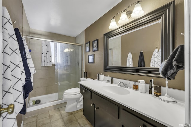 bathroom with vanity, toilet, and a shower with shower door