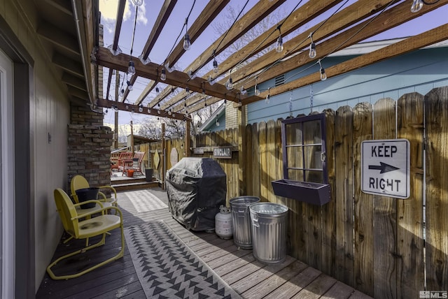 deck at dusk with a pergola and grilling area