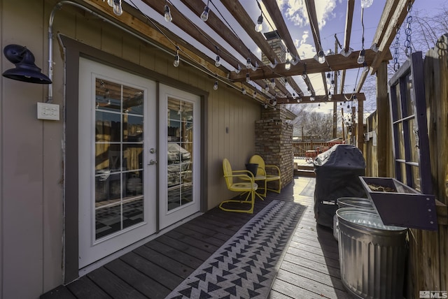 wooden deck featuring a pergola and french doors