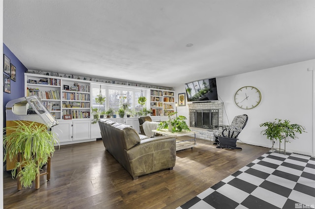 living room featuring a fireplace and dark wood-type flooring