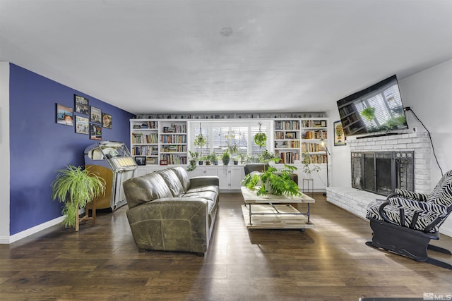 living room with a fireplace and wood-type flooring