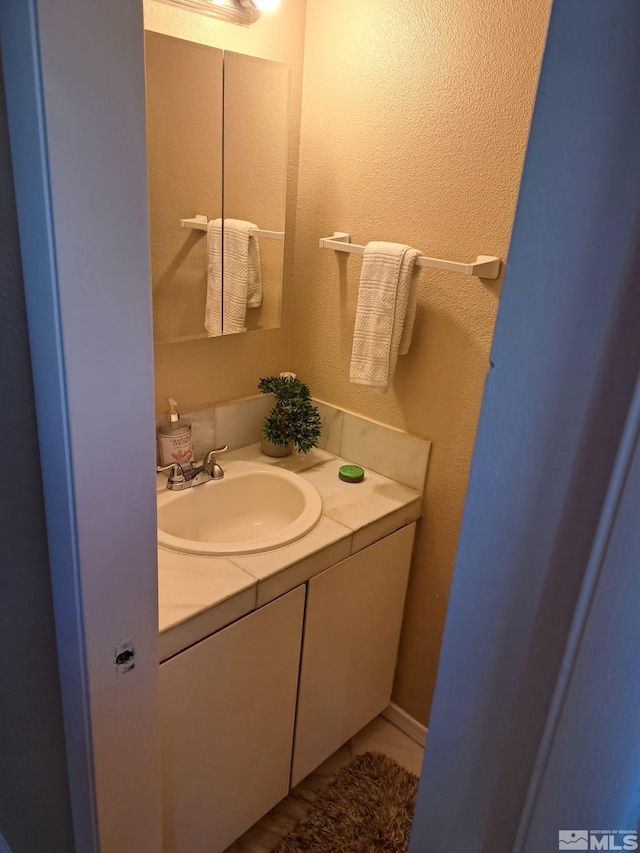 bathroom with tile patterned flooring and vanity