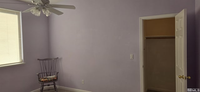 unfurnished bedroom with multiple windows, ceiling fan, and a closet