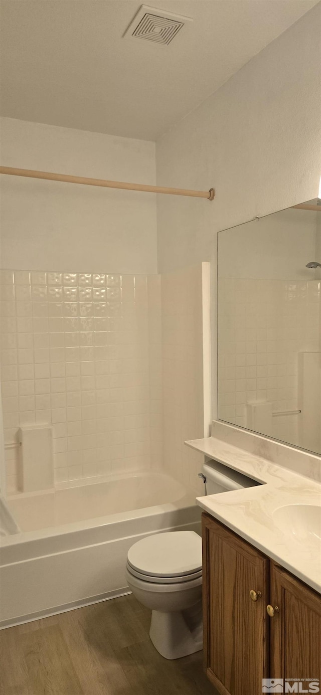 full bathroom with hardwood / wood-style flooring, vanity, toilet, and bathing tub / shower combination