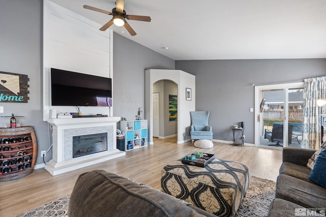 living room with light wood-type flooring and vaulted ceiling