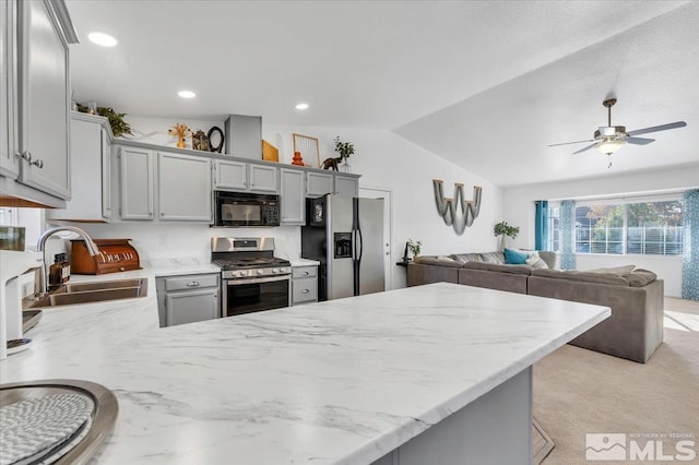 kitchen featuring gray cabinetry, stainless steel appliances, ceiling fan, sink, and lofted ceiling