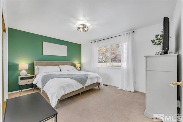 bedroom featuring light colored carpet