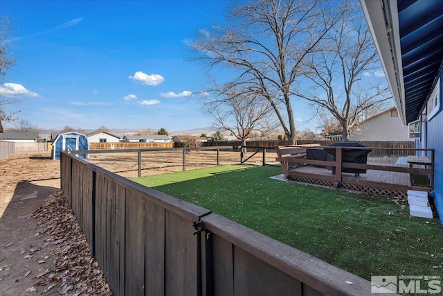 view of yard with a storage unit and a deck