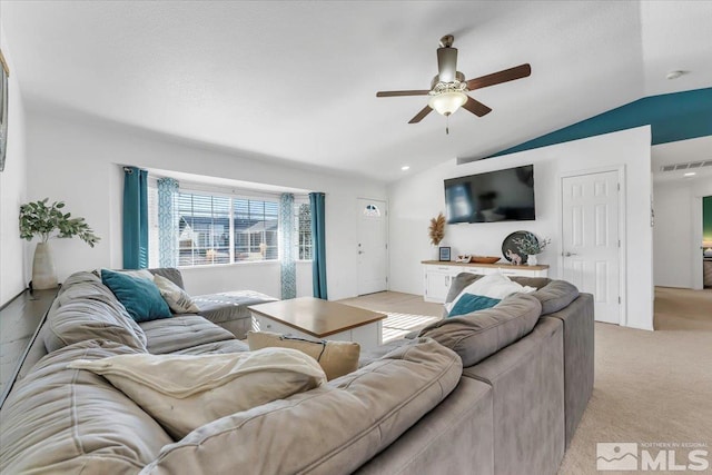 carpeted living room with ceiling fan and lofted ceiling