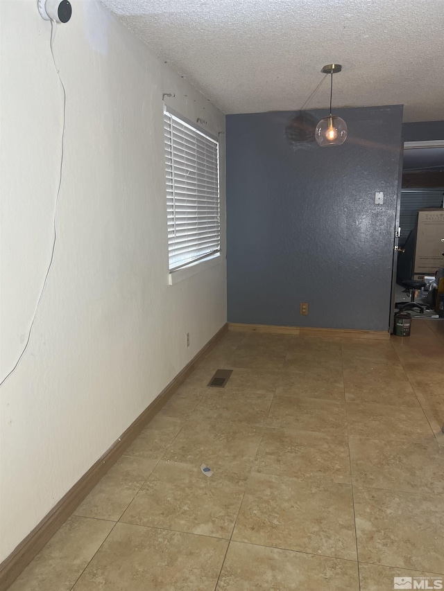 spare room with a textured ceiling