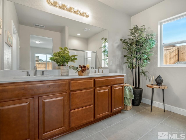 bathroom with vanity, tile patterned floors, and a shower with shower door