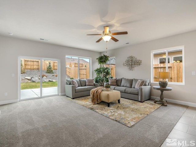 carpeted living room with ceiling fan