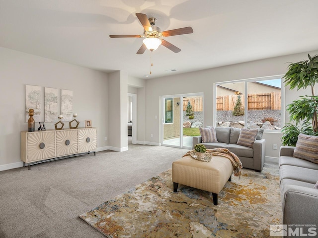 living room with carpet flooring, ceiling fan, and a healthy amount of sunlight