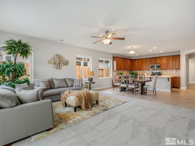 living room with ceiling fan and light tile patterned floors