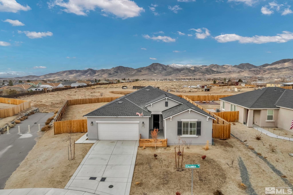 ranch-style home with a mountain view and a garage