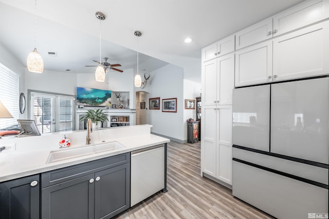 kitchen featuring white cabinetry, sink, ceiling fan, built in refrigerator, and dishwashing machine