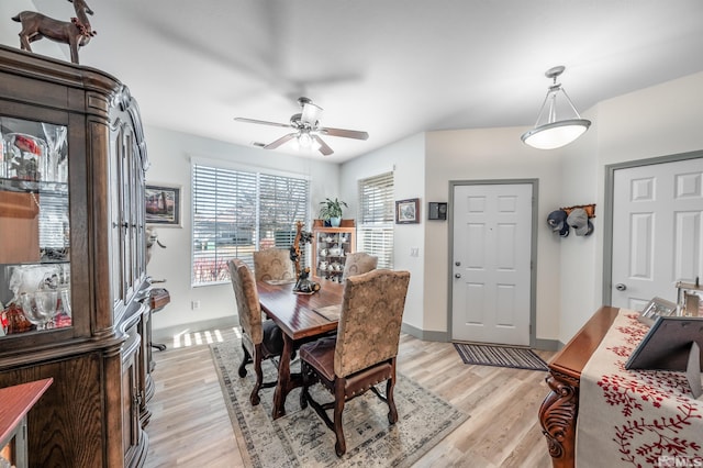 dining space with ceiling fan and light hardwood / wood-style floors