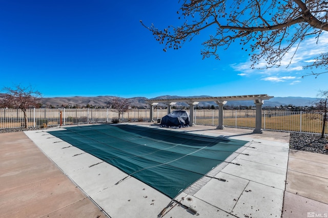 view of swimming pool featuring a mountain view and a patio area