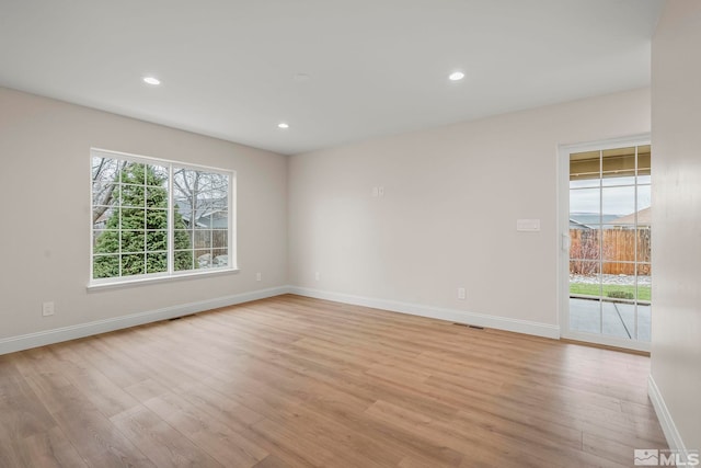 spare room with light hardwood / wood-style flooring