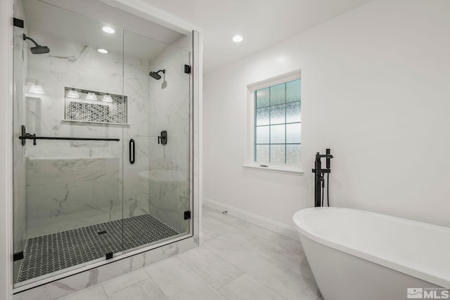 bathroom featuring independent shower and bath