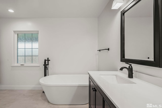 bathroom featuring a tub to relax in and vanity